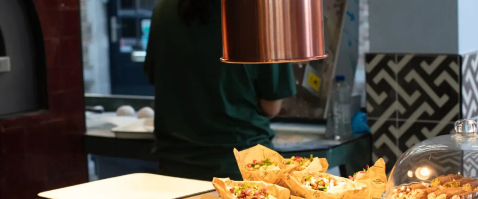 Fresh pitas under the heat lamps in a Barouche kitchen