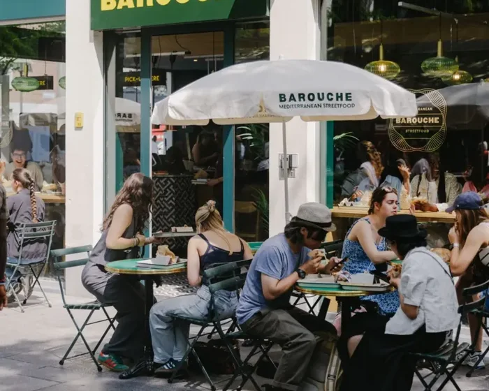 A busy Barouche terrace with guests eating outside